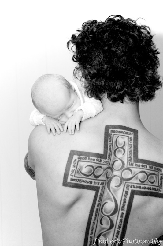 Dad with back tattoo and sleeping baby on shoulder - newborn portrait photography sydney